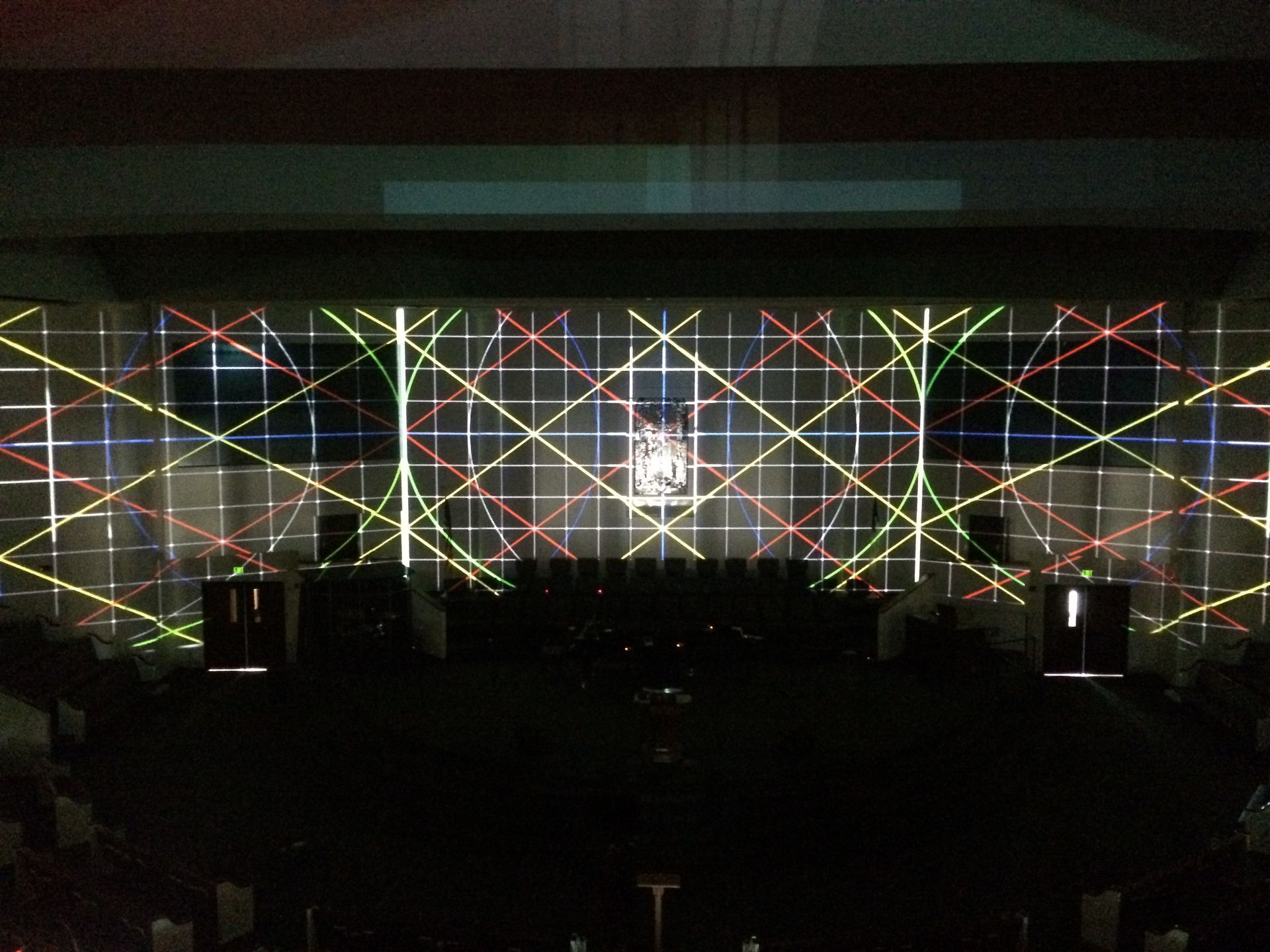A stage with a grid of lights projected on it