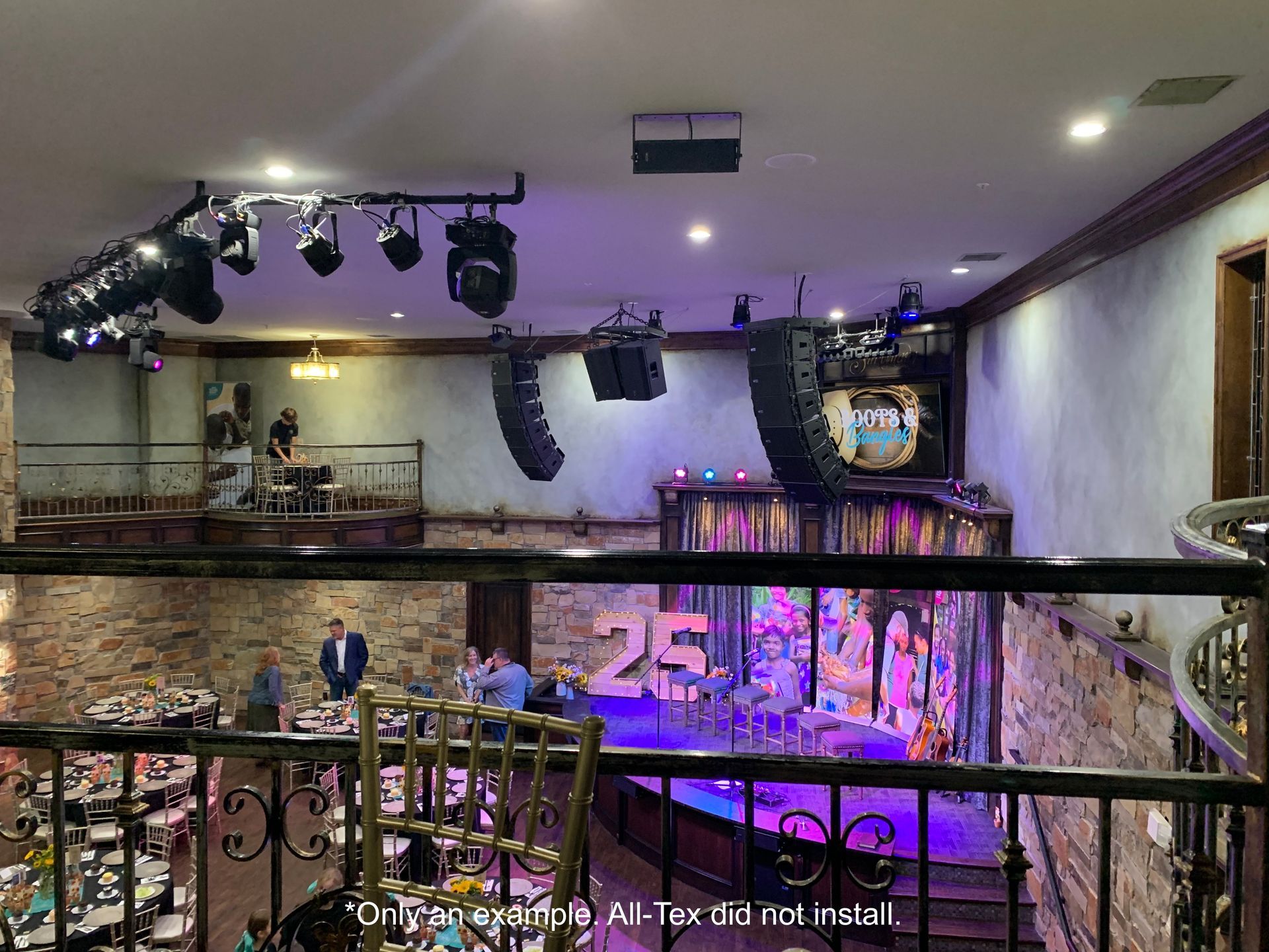 A view of a stage from the balcony of a restaurant.