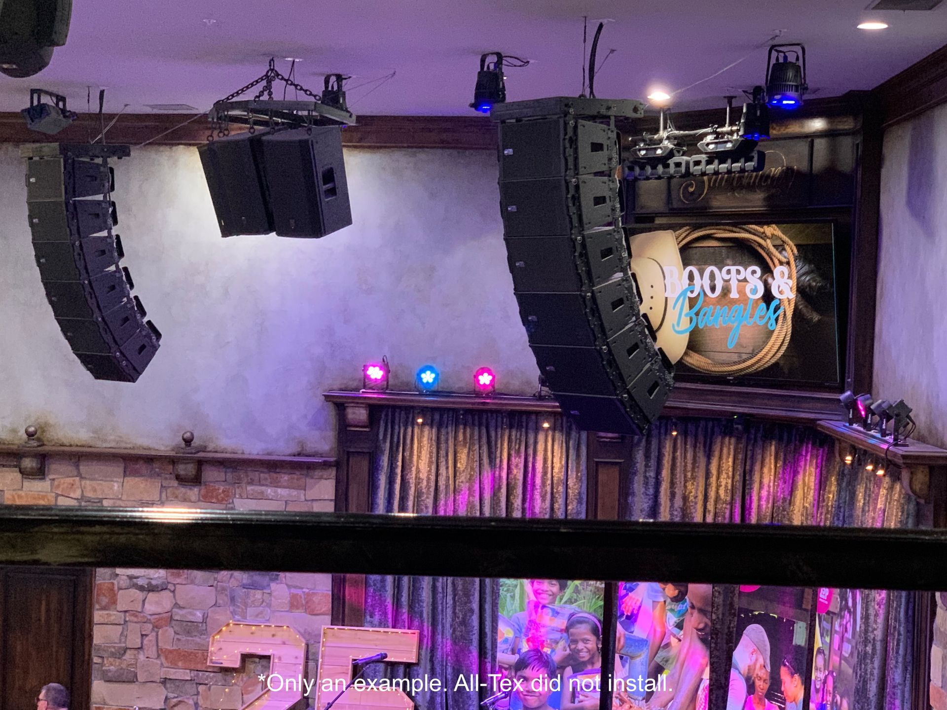 A stage with a lot of speakers and lights on it.