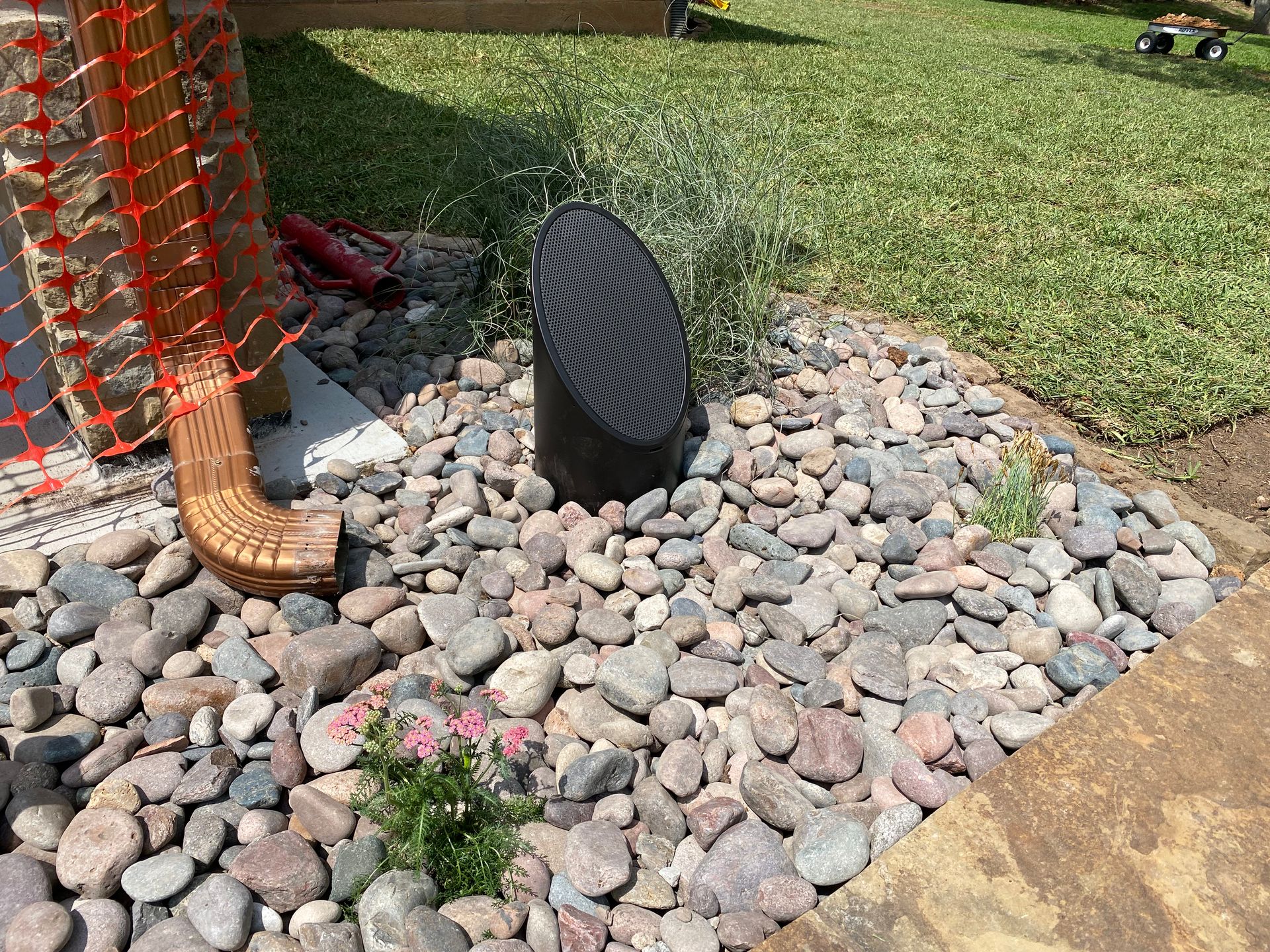 A pair of cowboy boots are sitting on top of a pile of rocks.