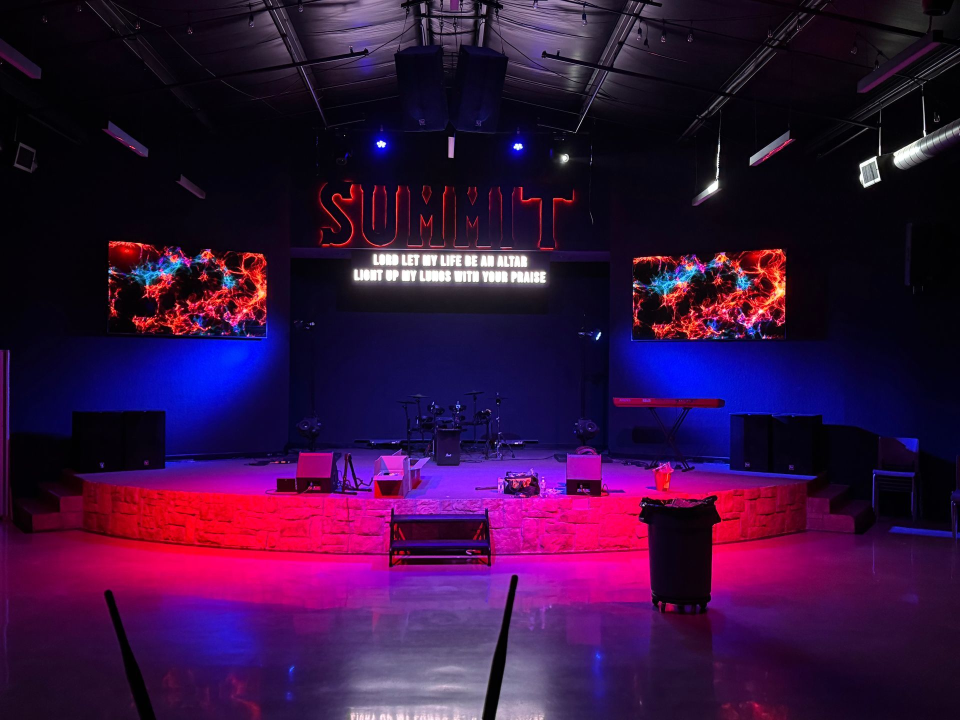 There is a stage in the middle of the room with a lot of lights on it.