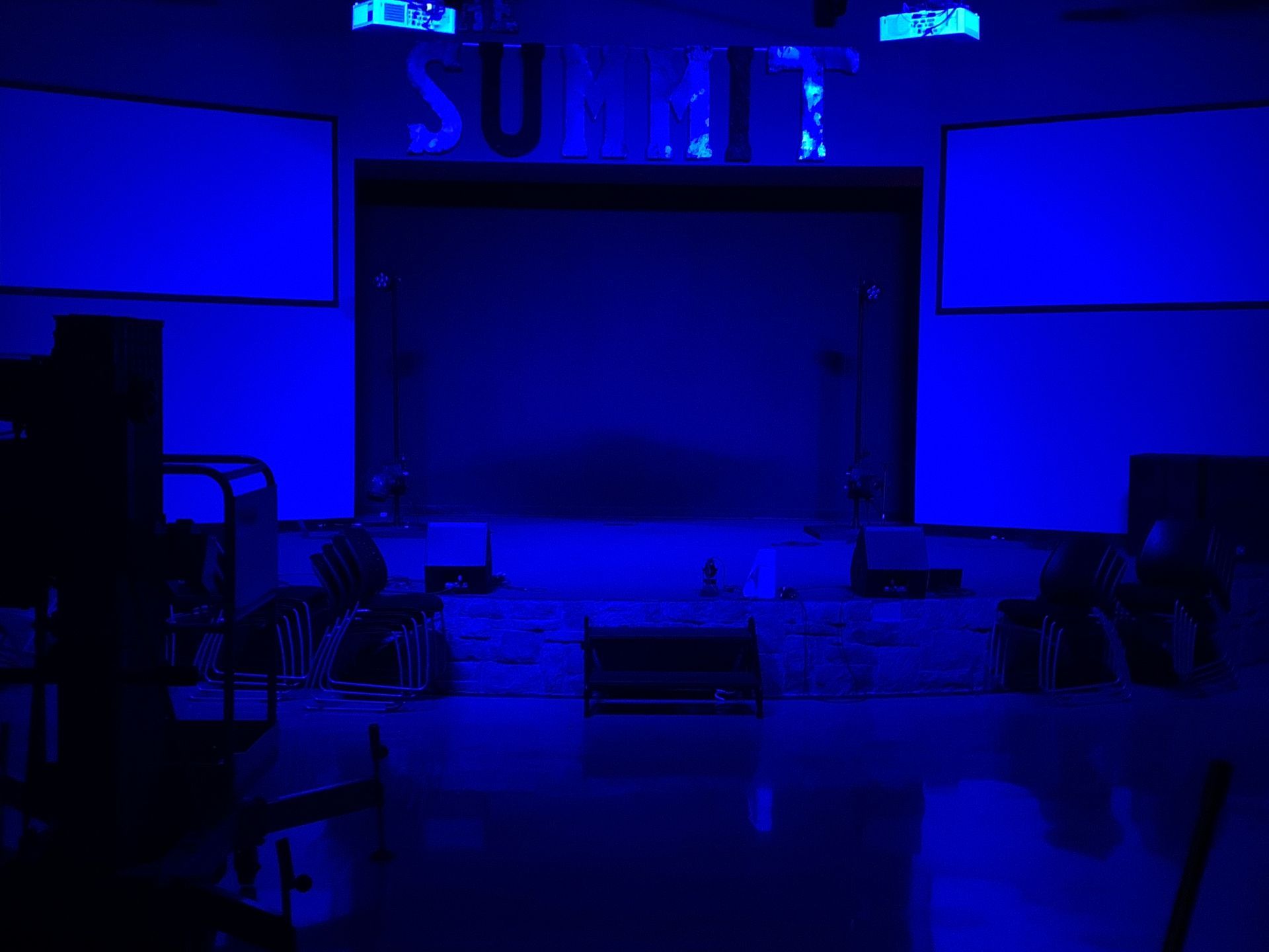 A dark room with blue lights on the walls and ceiling.