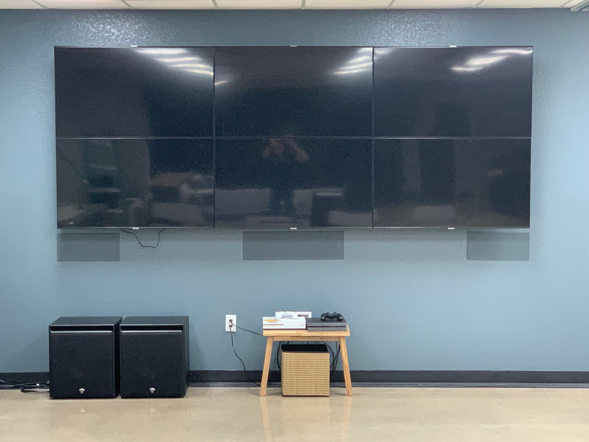 A large flat screen tv is hanging on a wall in a room.