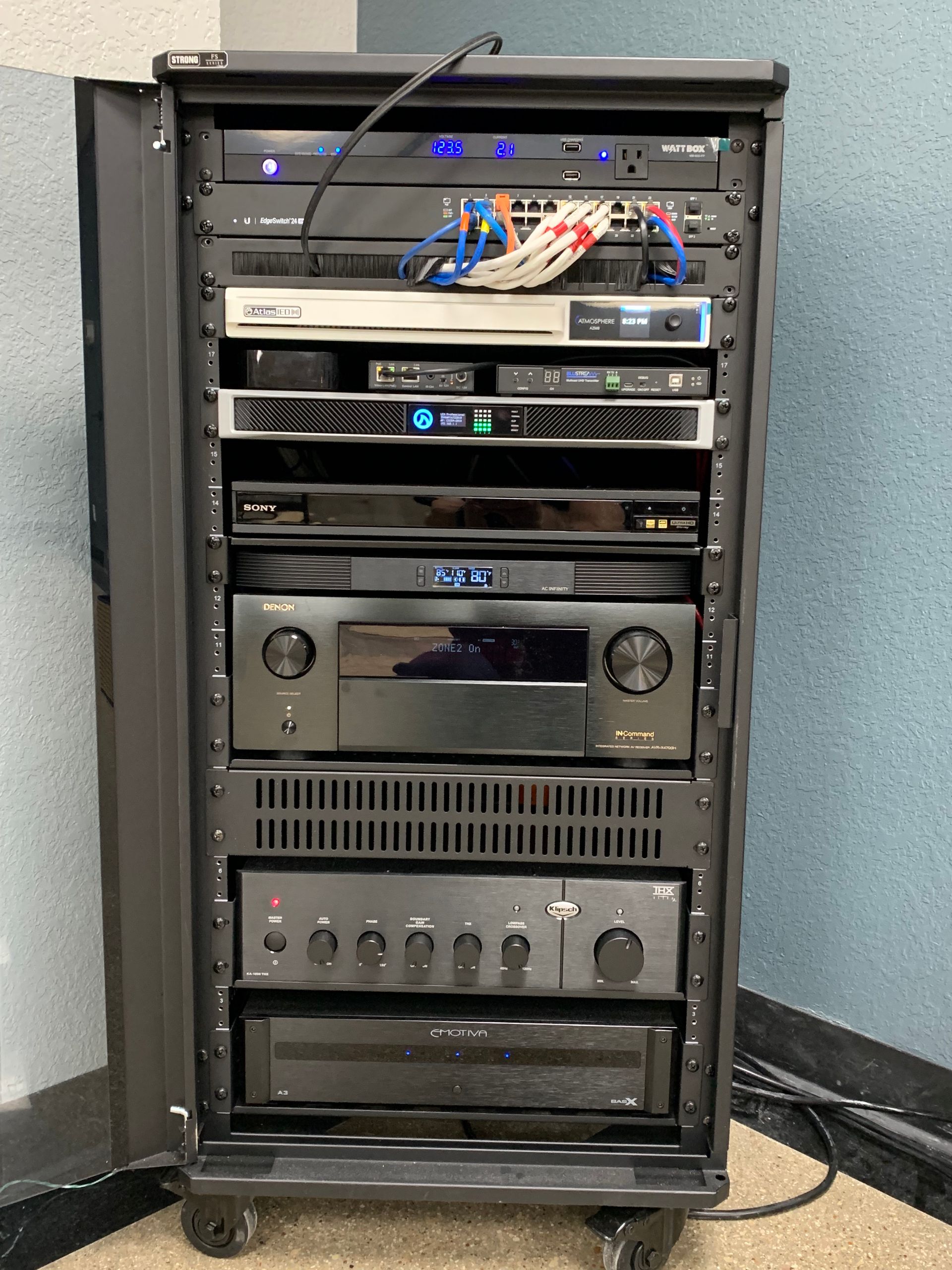 A rack with a lot of electronic equipment on it