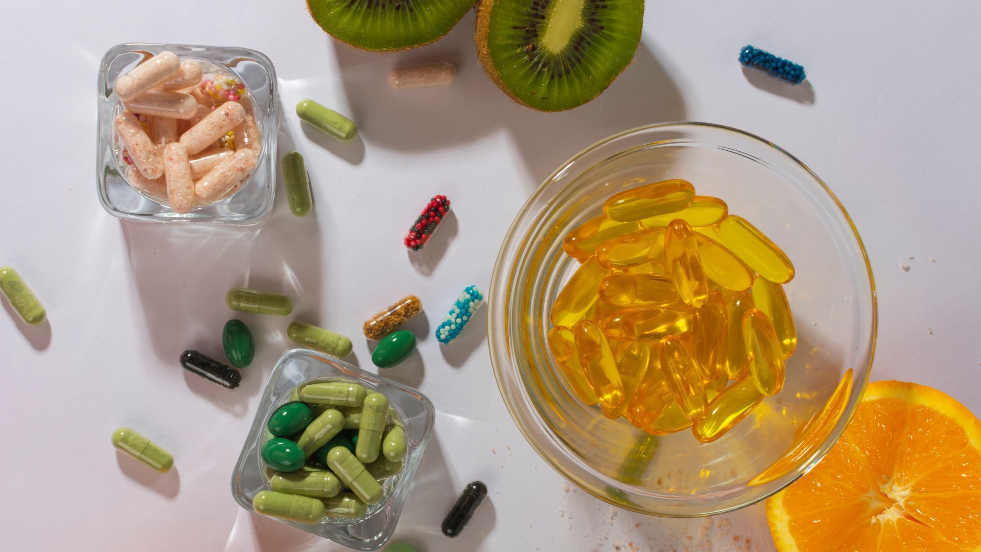 There are many different types of vitamins and supplements on the table.
