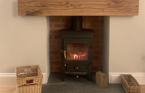 wood burning stove in brick fireplace