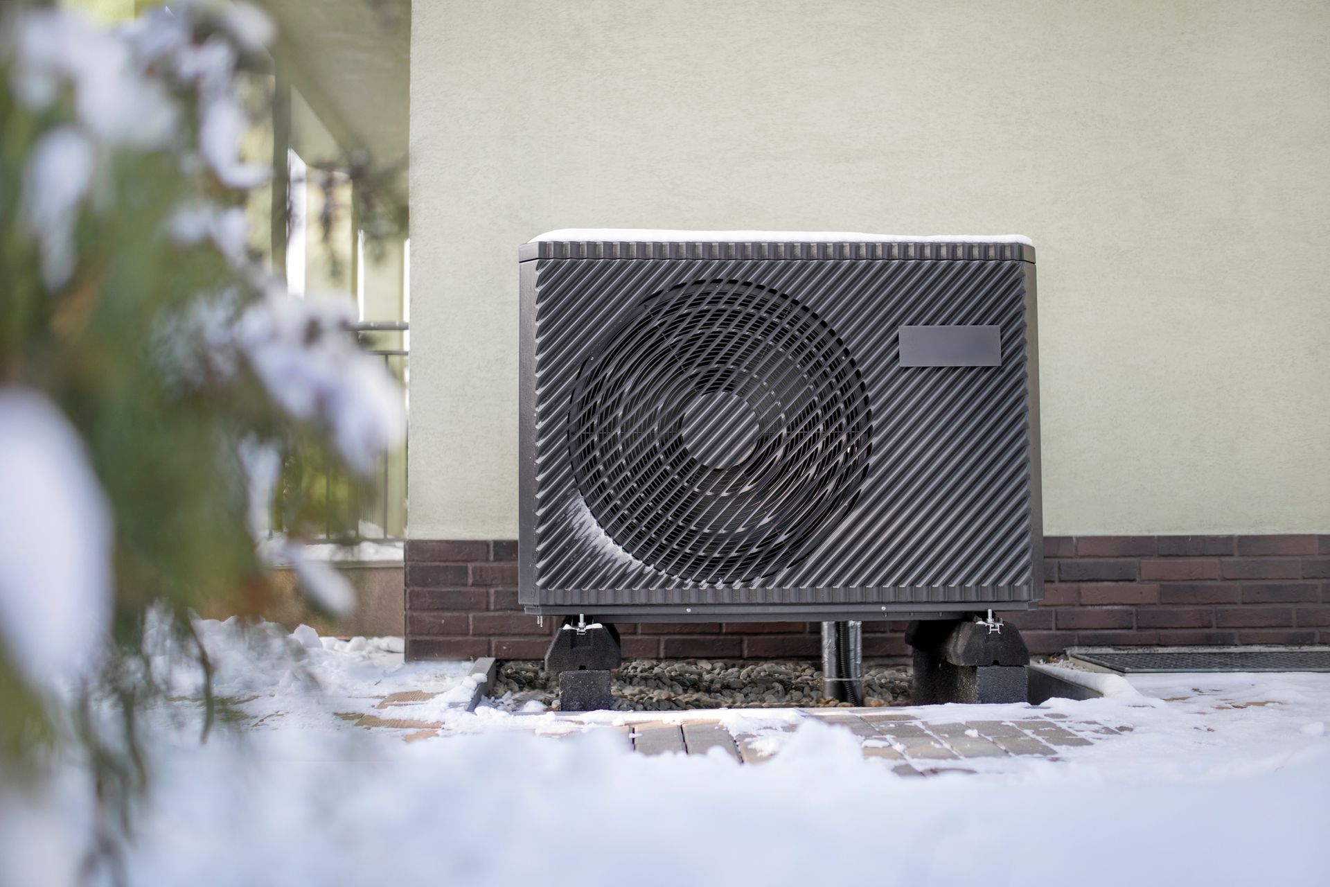 Technician performing maintenance on a residential heat pump to prepare for winter in Staten Island.