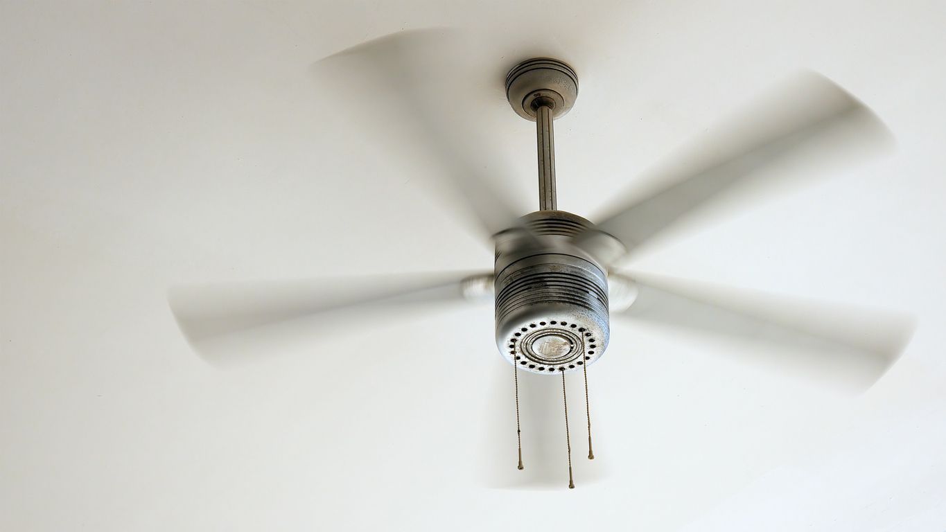 Ceiling fan rotating clockwise in a New York home to help circulate warm air during winter.