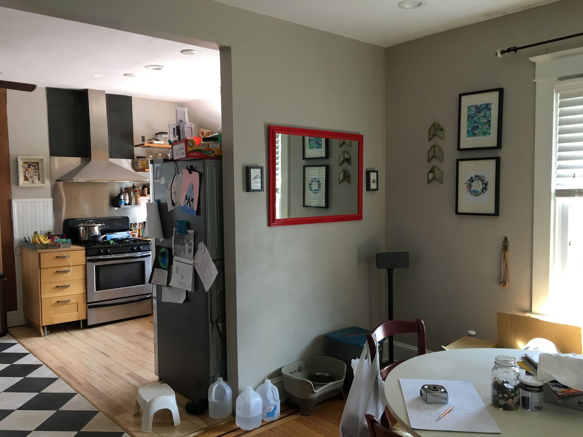 A kitchen with a table and chairs and a refrigerator.