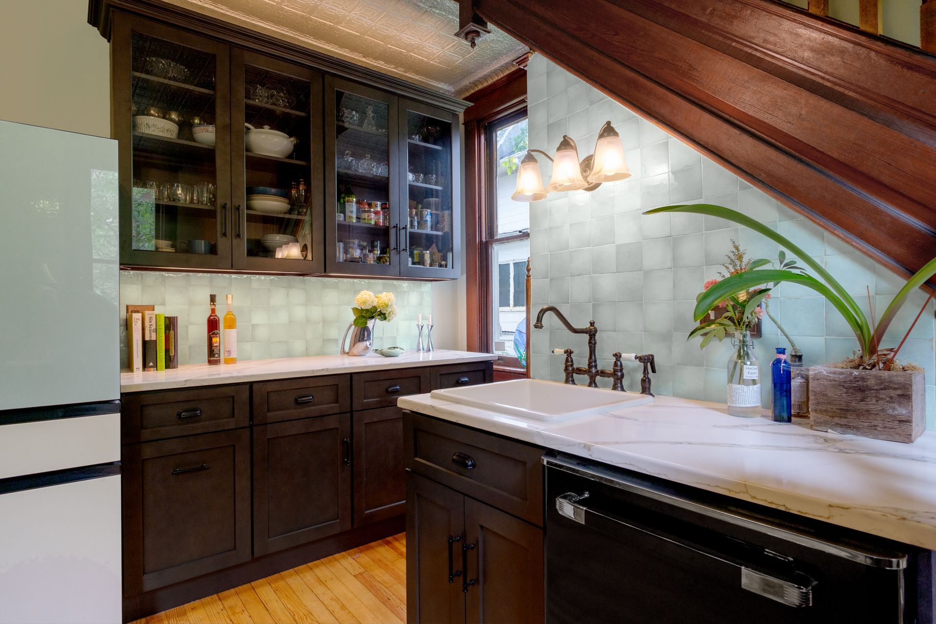 A kitchen with a stove , refrigerator and cabinets, after renovation.