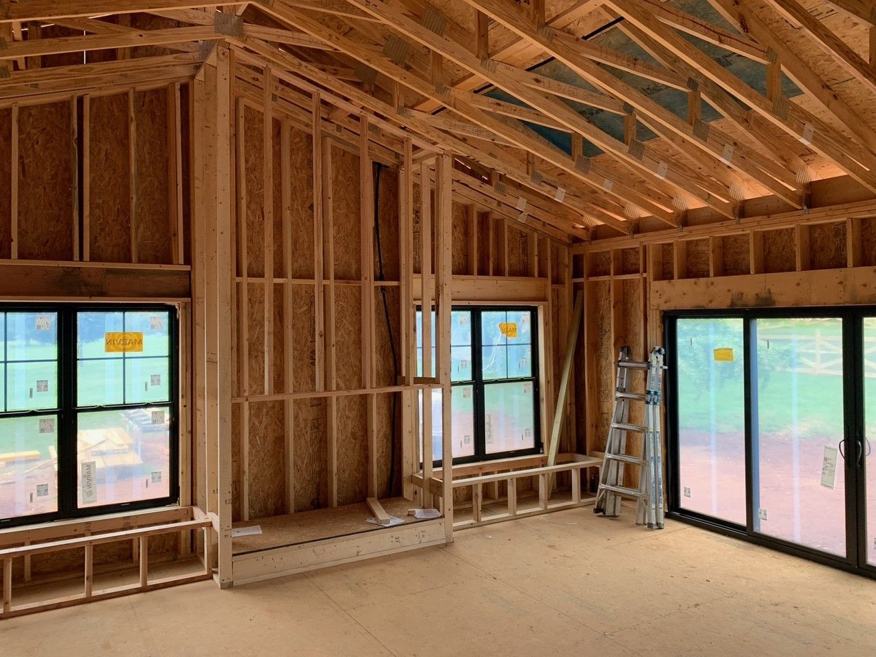 A house is being remodeled and a vacuum cleaner is in the middle of the room.