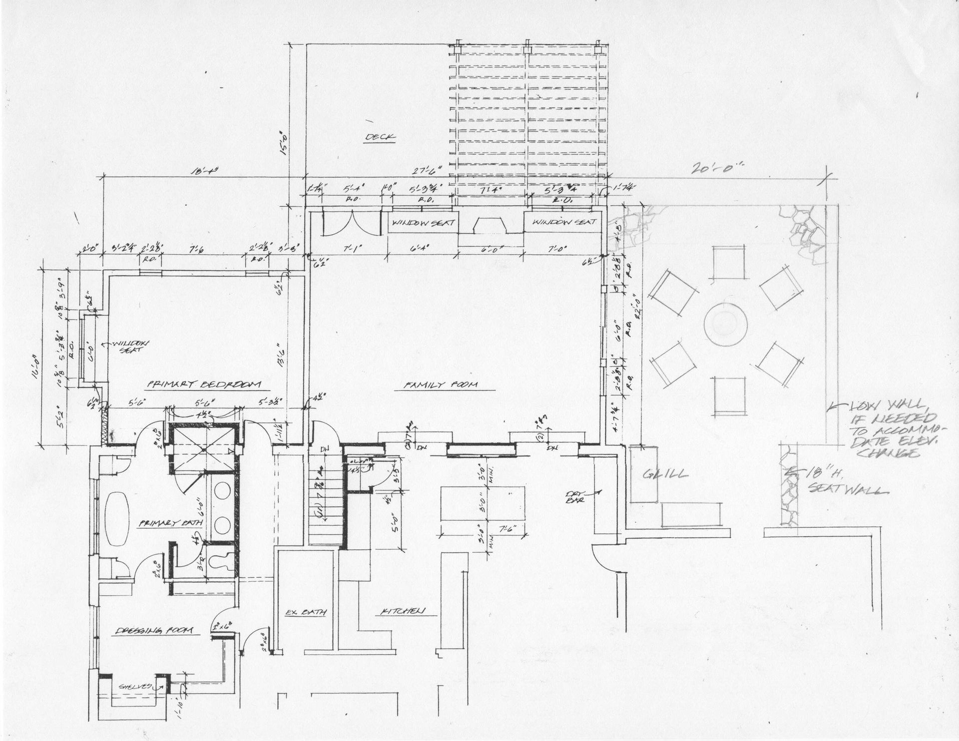 A house with a red roof is surrounded by blueprints.