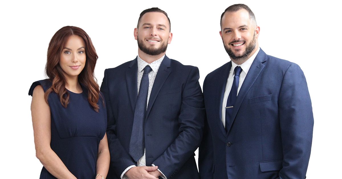 Three people in suits and ties are posing for a picture.