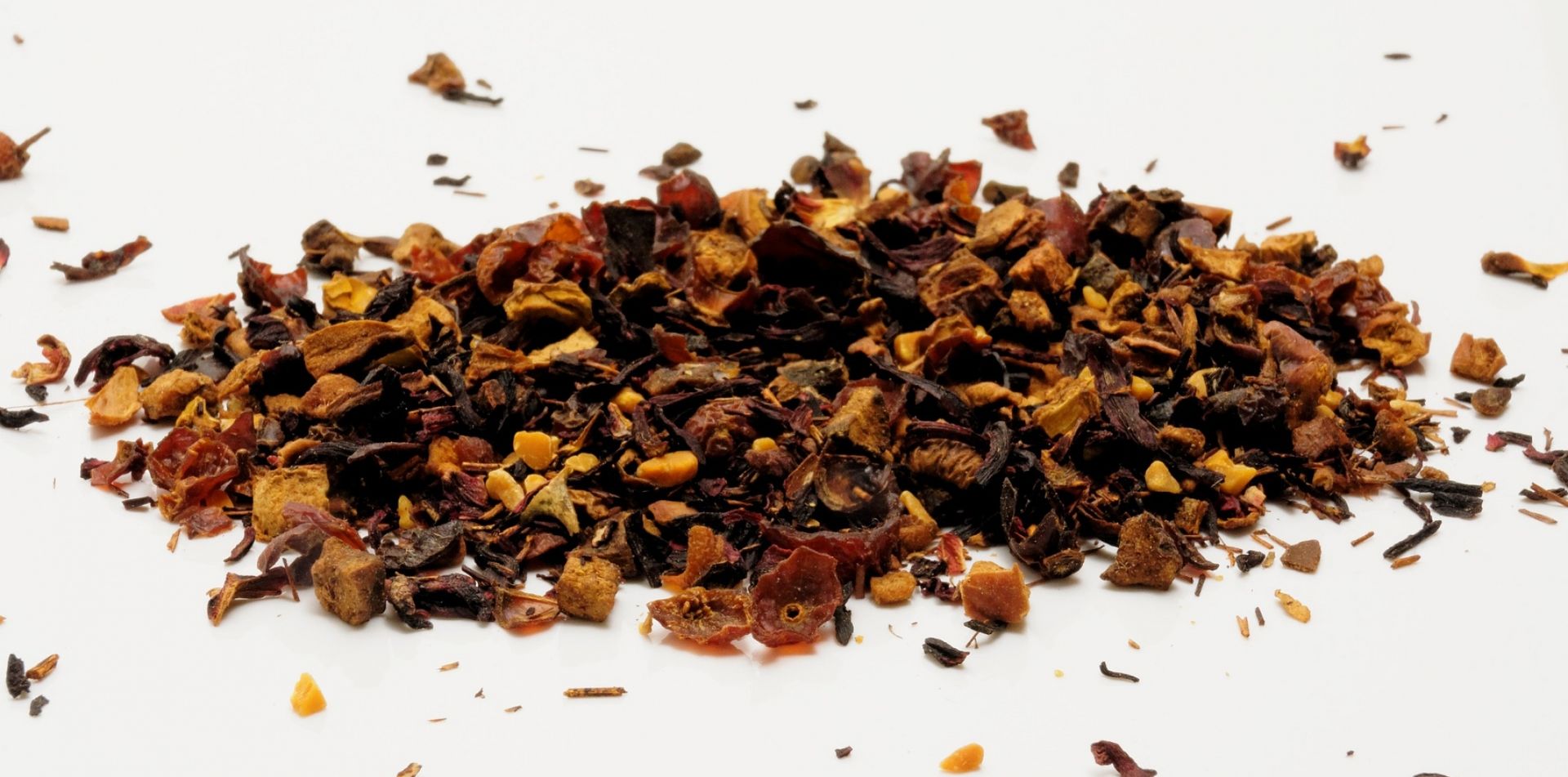 A pile of dried fruit on a white surface.