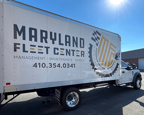 A maryland fleet center truck is parked on the side of the road.