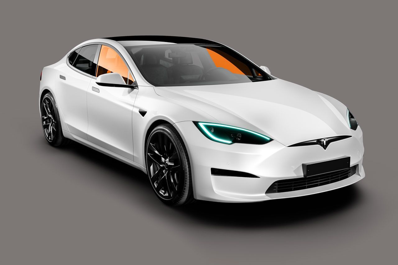 A white tesla model s is sitting on a gray surface.