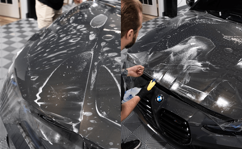 A man is covering the hood of a car with plastic wrap.