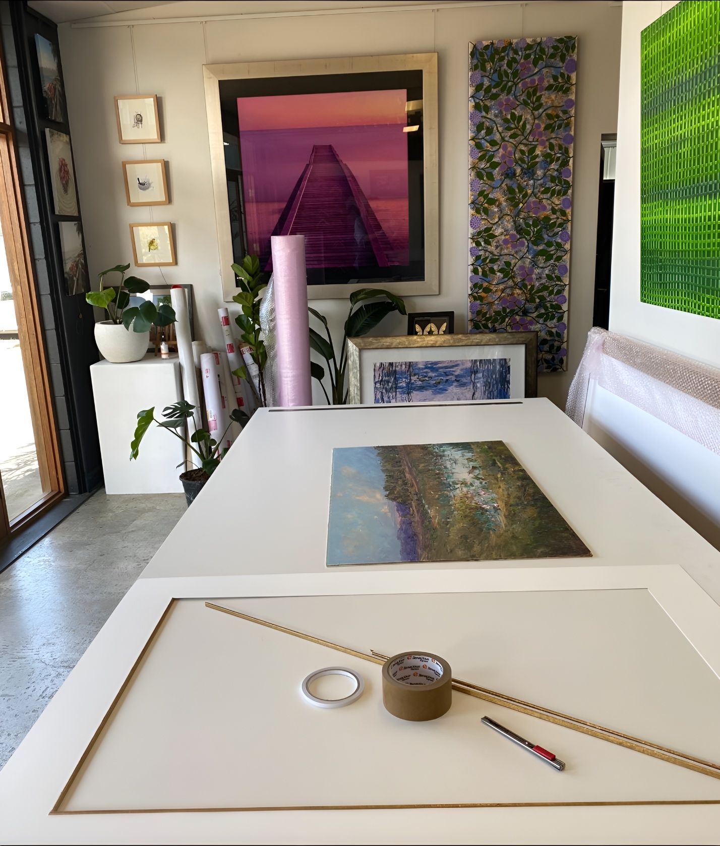 A table with a painting on it and a roll of tape — The Picture Framer In Parramatta Park, QLD