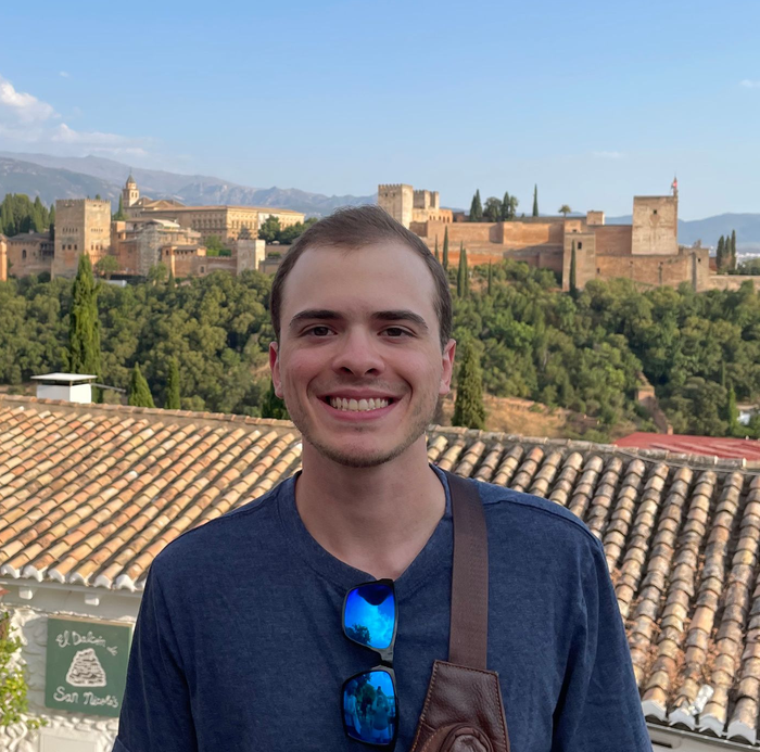 A picture of me posing in front of the Alhambra Fortress in Granada, Spain.