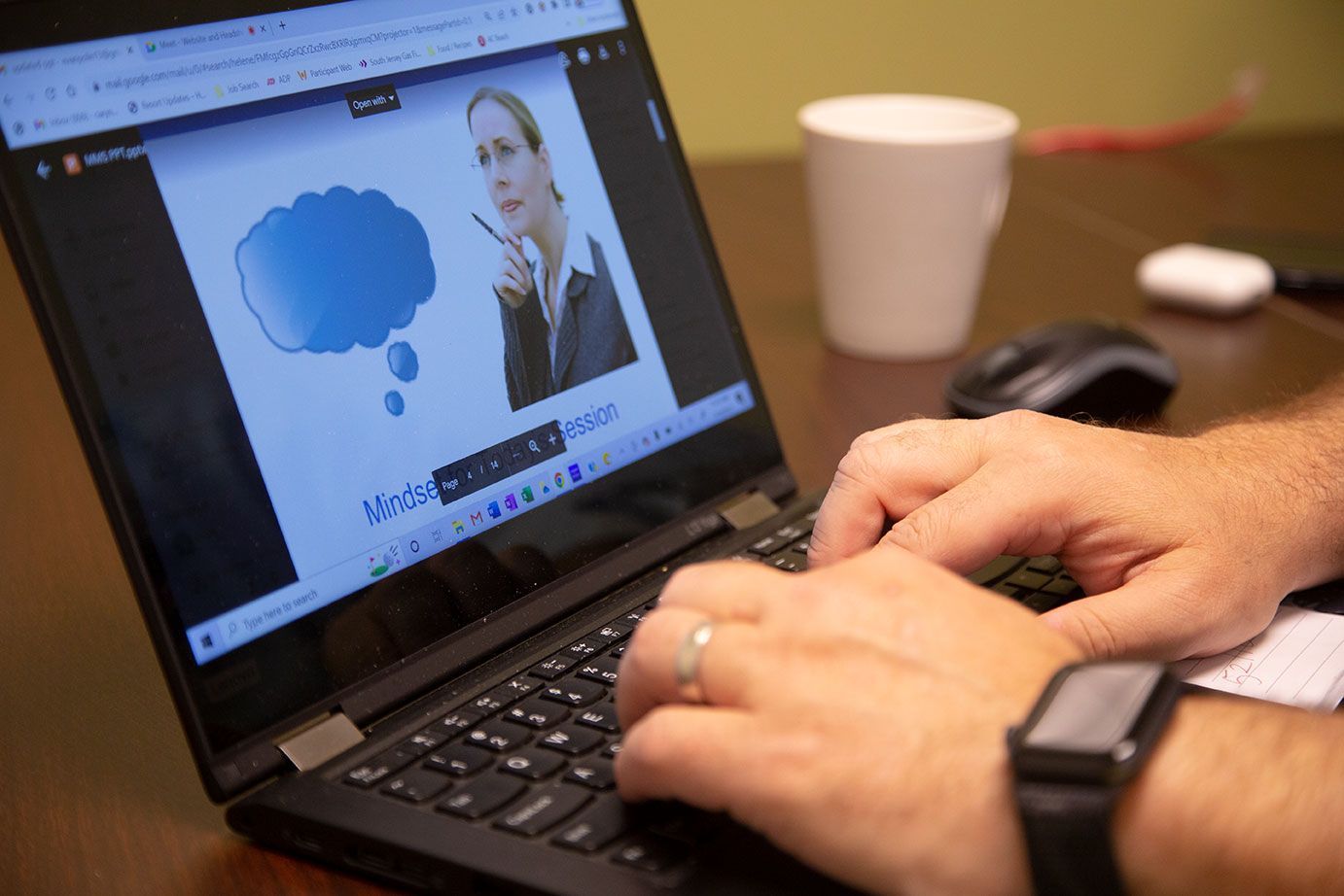 a person is typing on a laptop computer with a woman in a thought bubble on the screen .