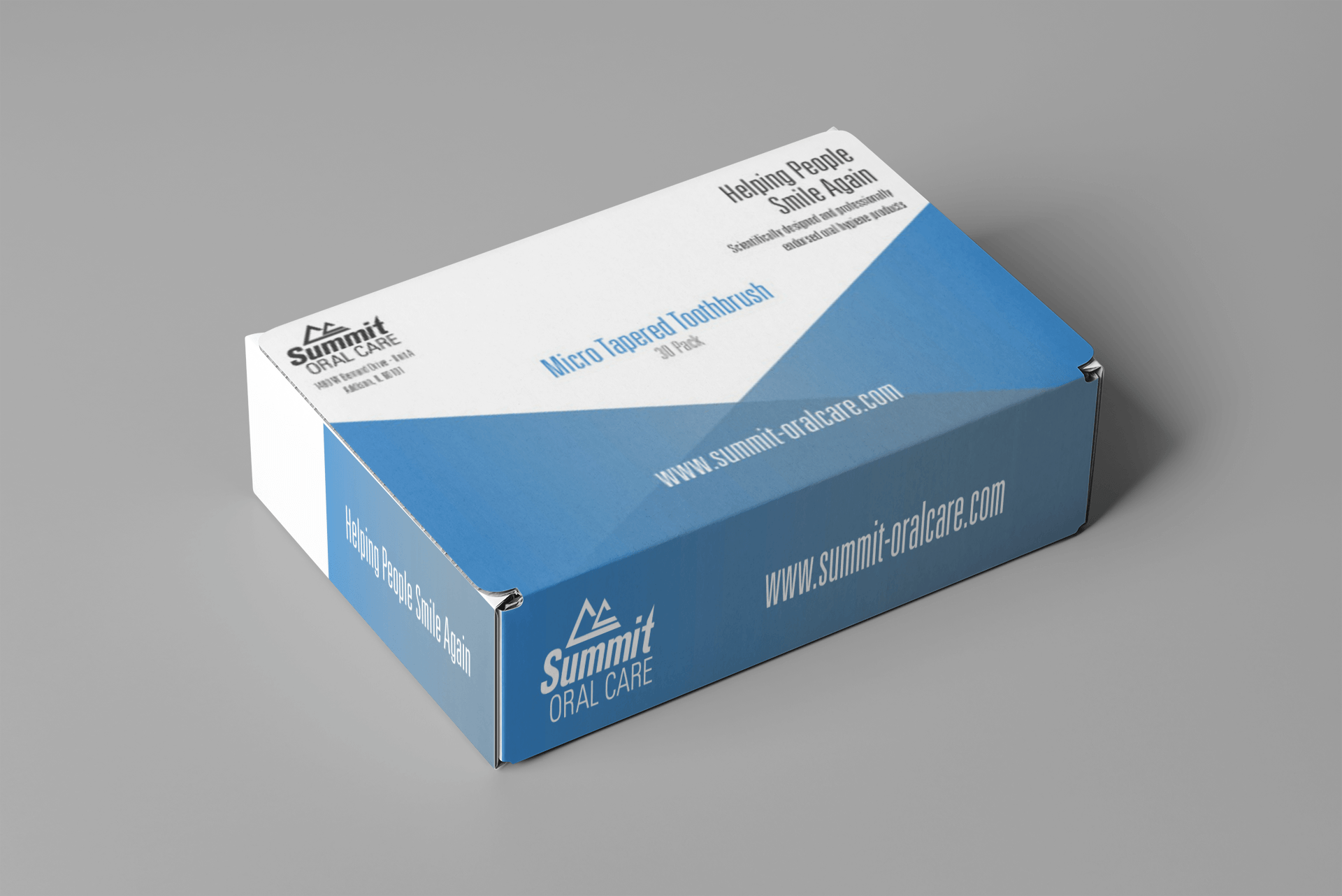a blue and white box is sitting on a gray surface .