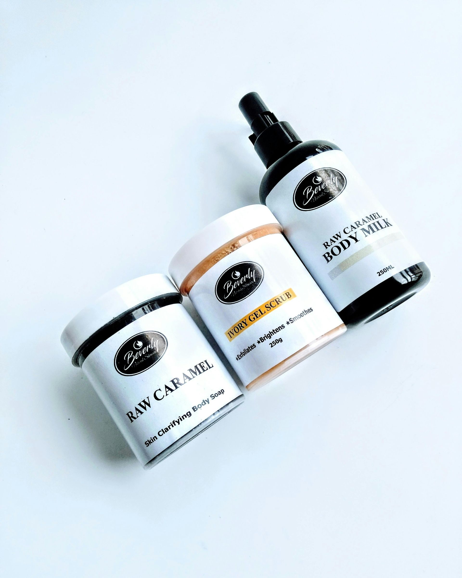 Three bottles of cosmetics are sitting next to each other on a white surface.