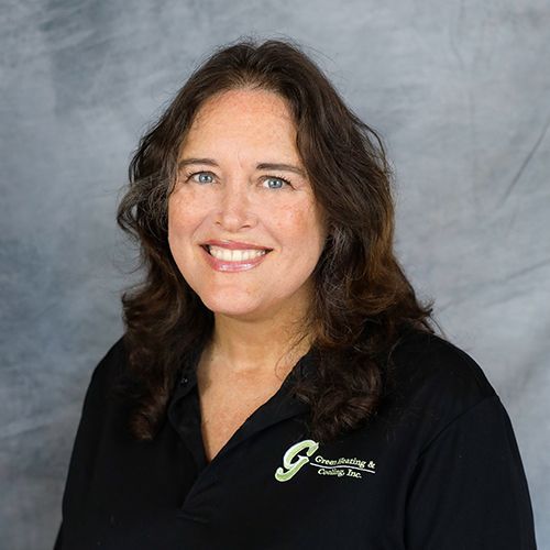 Woman with long brown hair smiling, wearing black shirt with 