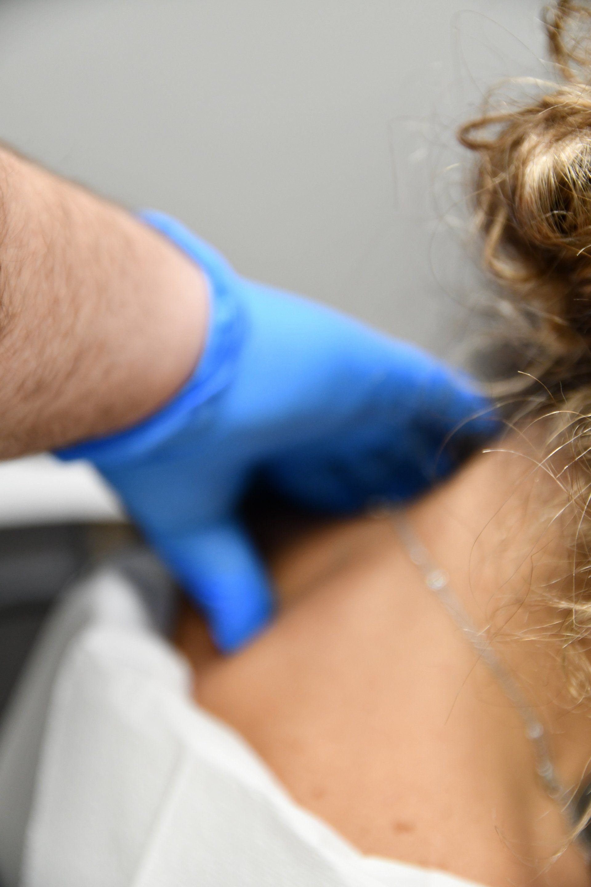 chiropractor checking on patients neck after a car accident