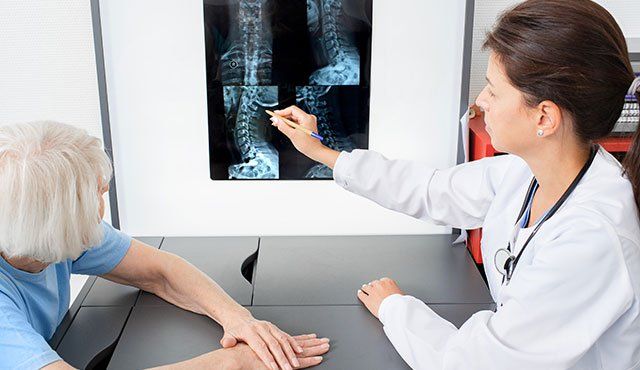 Doctor going over Xray picture with patient
