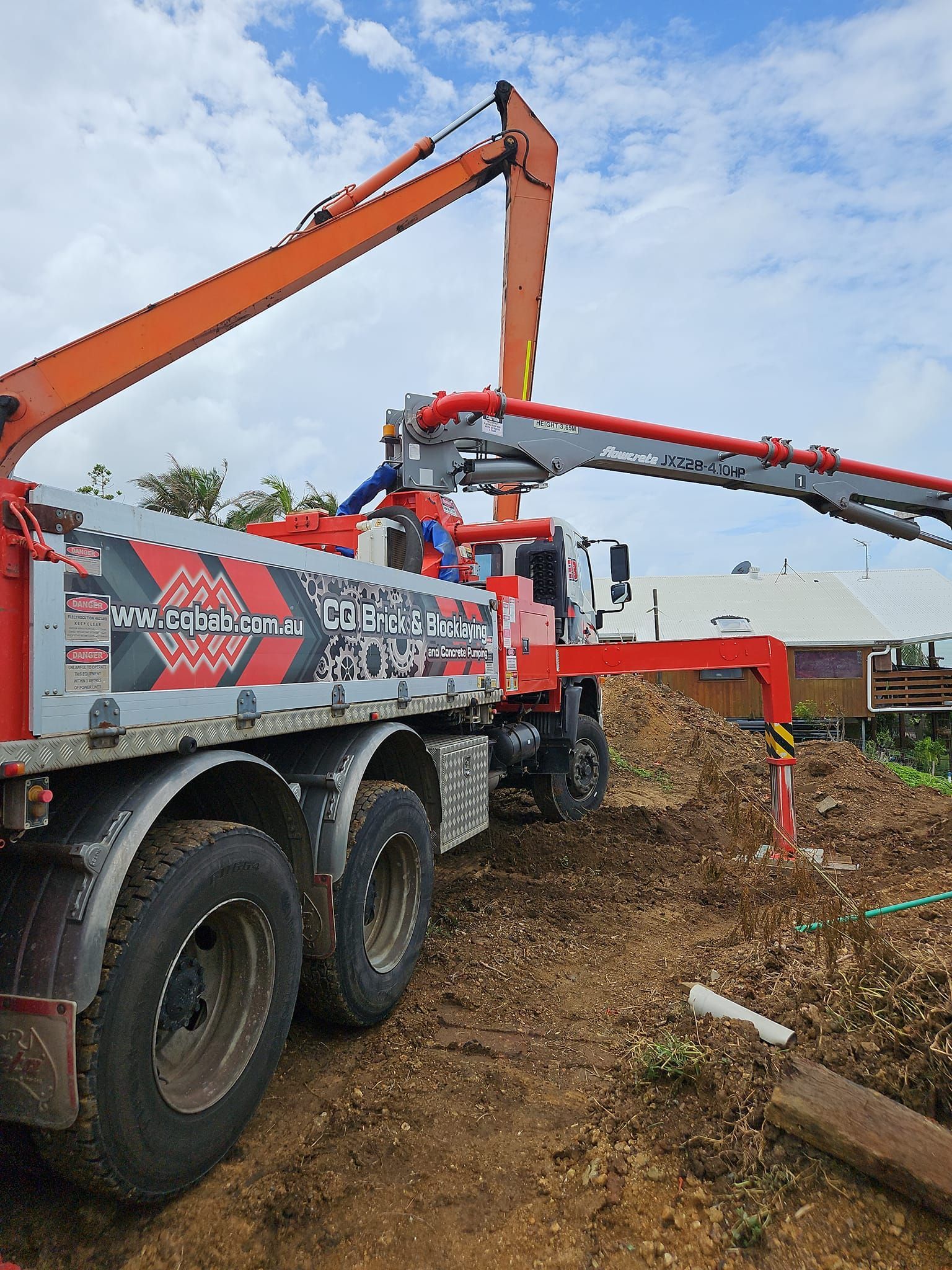 A Group Of Construction Workers Are Working On A Concrete Floor — CQBB Concreting Pumping Pty Ltd In Barmaryee, QLD