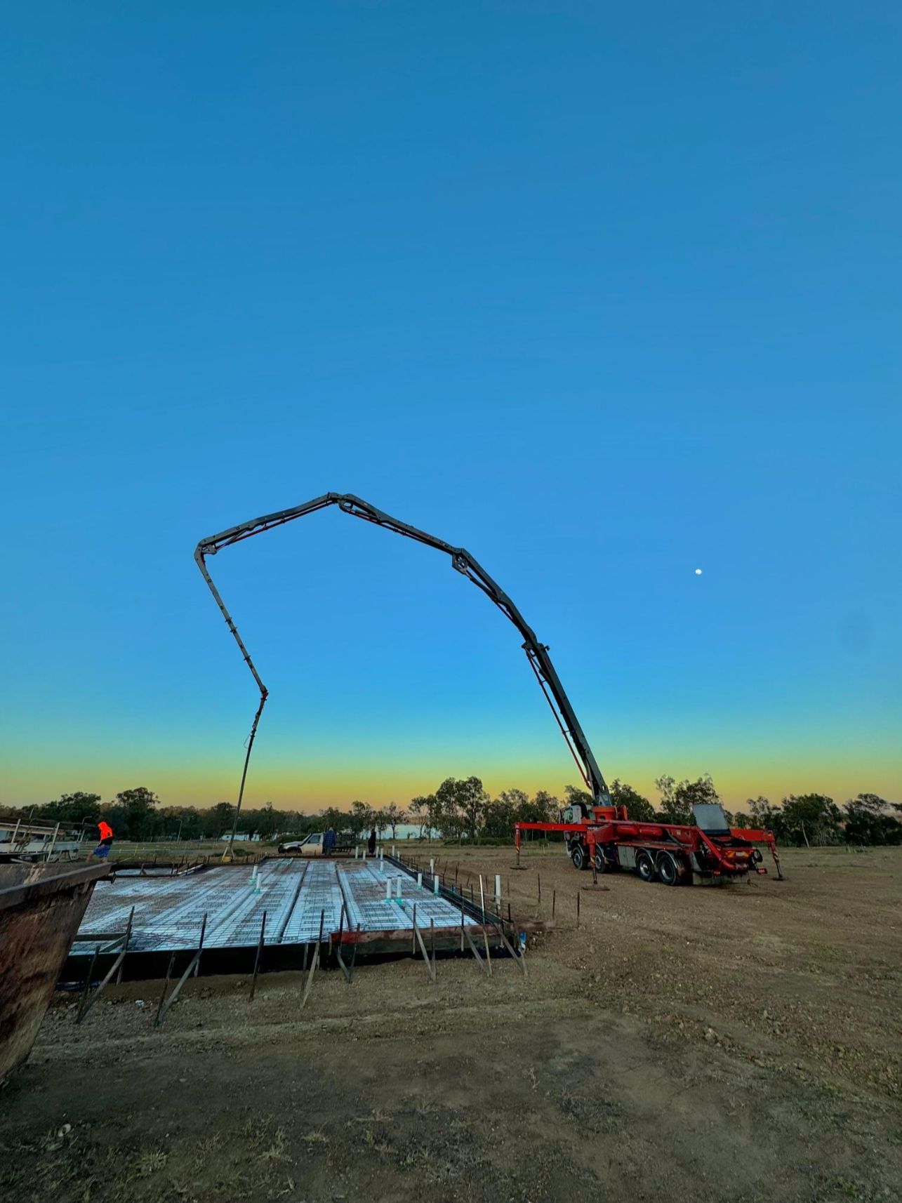 A Crane Is Pumping Concrete Into A Foundation At A Construction Site — CQBB Concreting Pumping Pty Ltd In Barmaryee, QLD