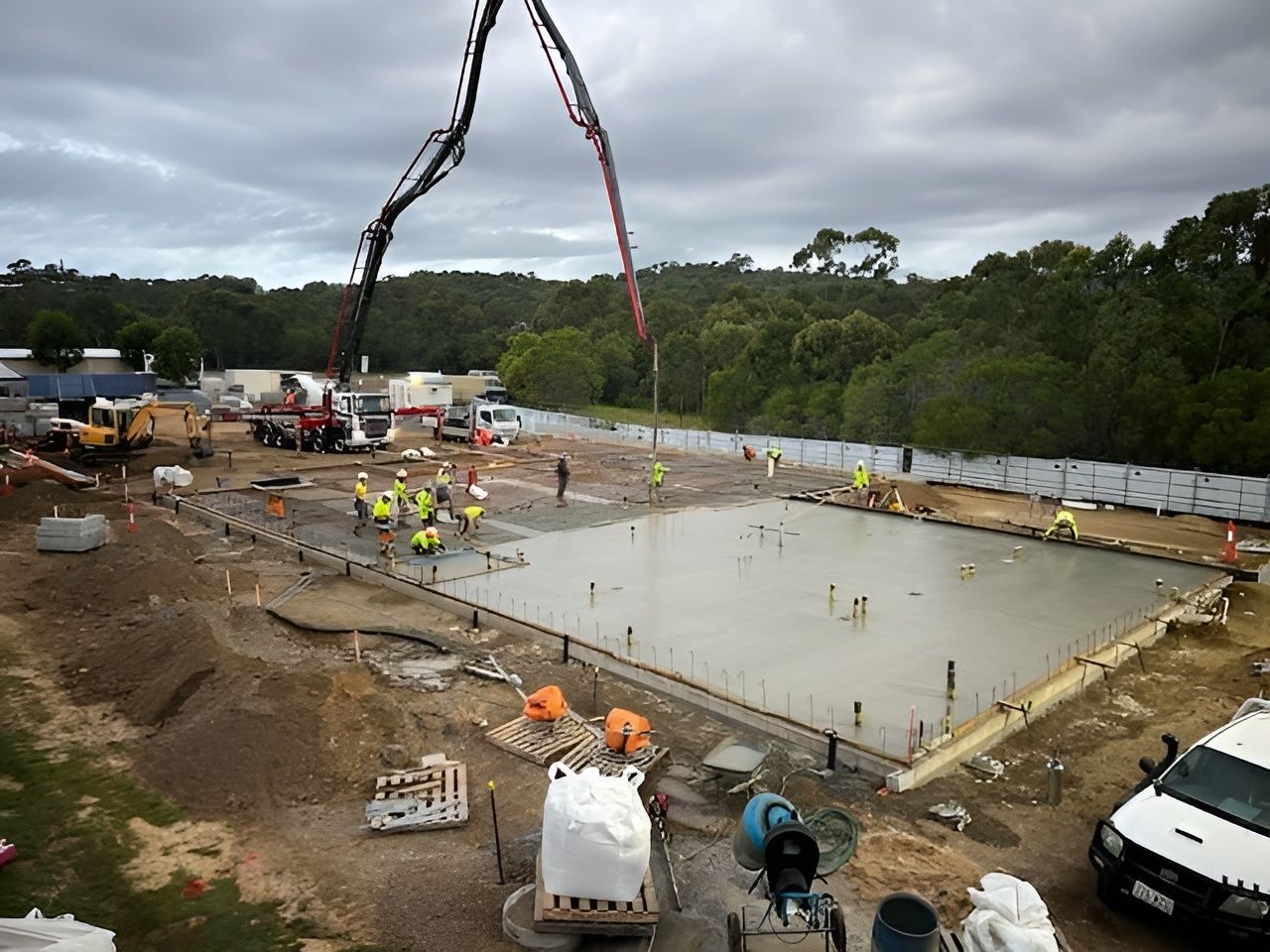 A Group Of Construction Workers Are Working On A Building — CQBB Concreting Pumping Pty Ltd In Barmaryee, QLD