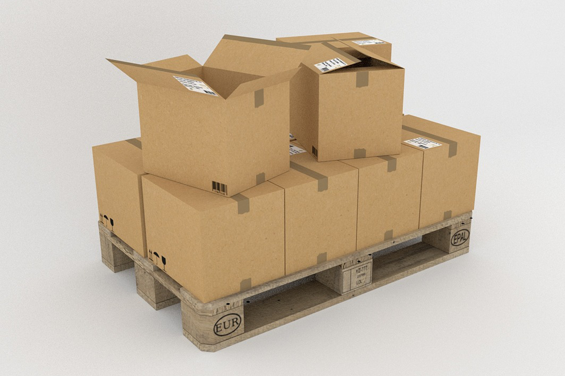 A wooden pallet filled with cardboard boxes on a white background