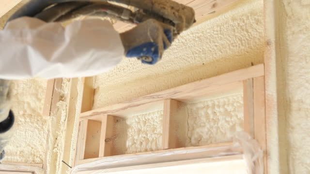an expert in spray foam insulation helping a retail business place with proper insulation