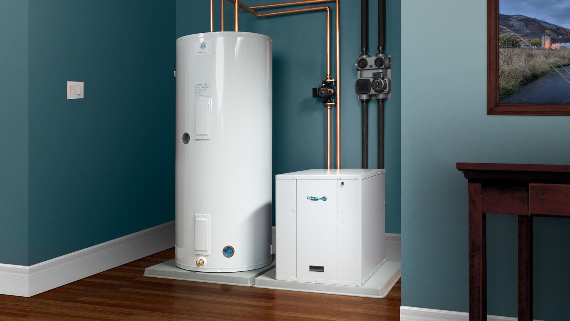 White water heater and furnace in a blue-walled room, with copper pipes and a framed photo.
