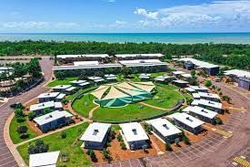 An aerial view of a resort with a circle of buildings in the middle.