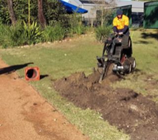 Digging lawn with machine  — Electricians in Fullerton Cove, NSW