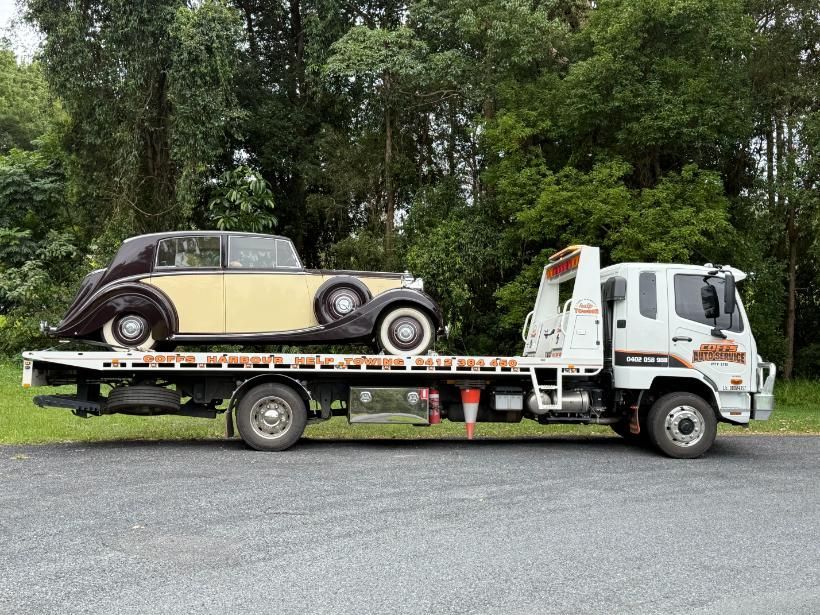 An Old Car is Being Towed by a Tow Truck — Coffs Tow Trucks In Macksville, NSW