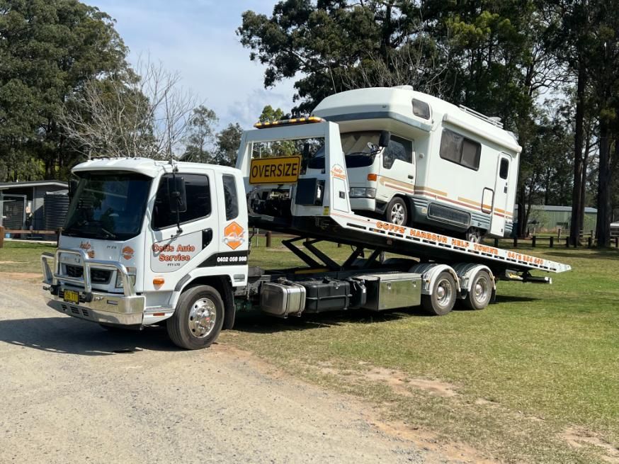 A Tow Truck is Carrying a Camper on the Back of It — Coffs Tow Trucks In North Boambee Valley, NSW