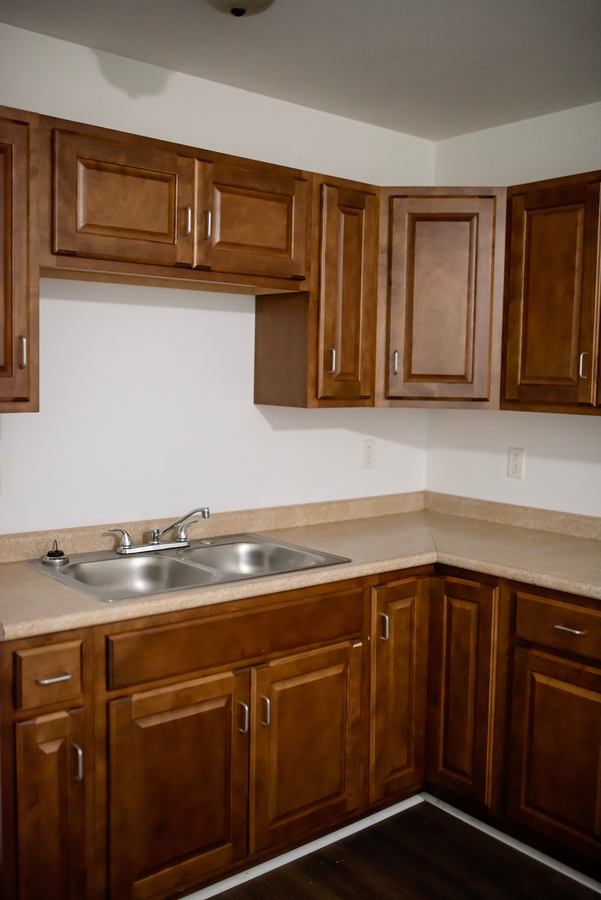 A kitchen with wooden cabinets and a sink