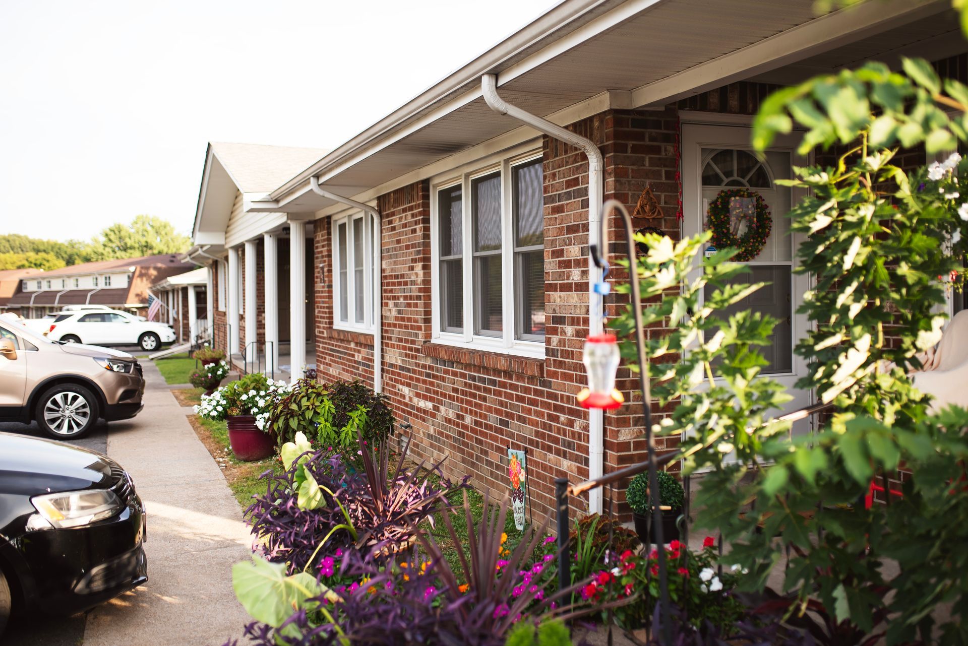 A brick house with a bird feeder in front of it