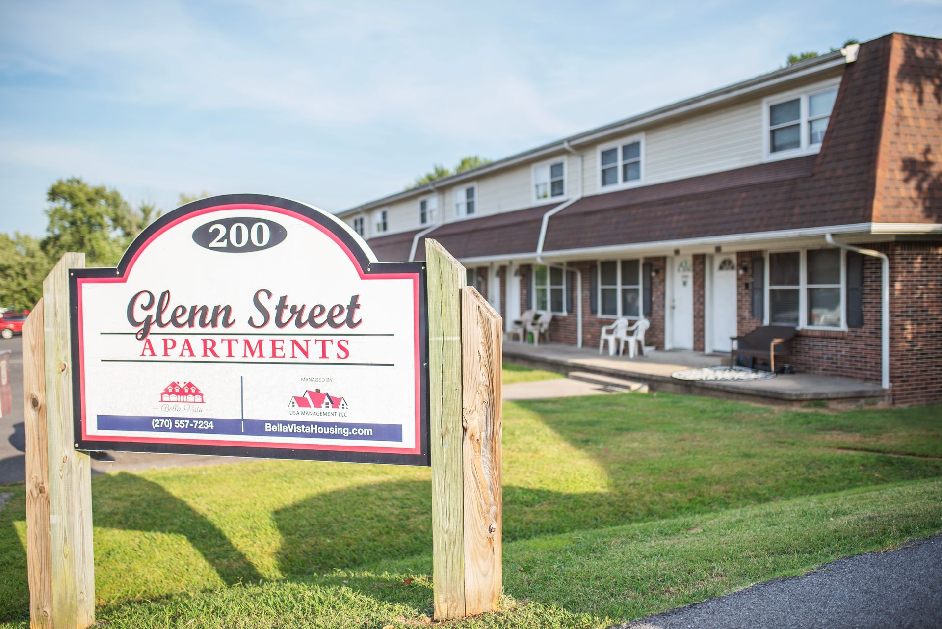 A sign for glenn street apartments is in front of a building.