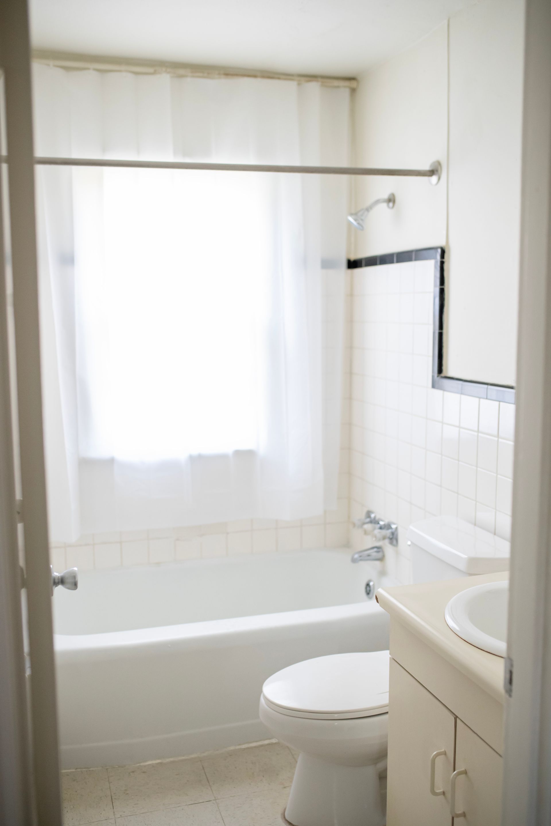 A bathroom with a toilet , sink and bathtub