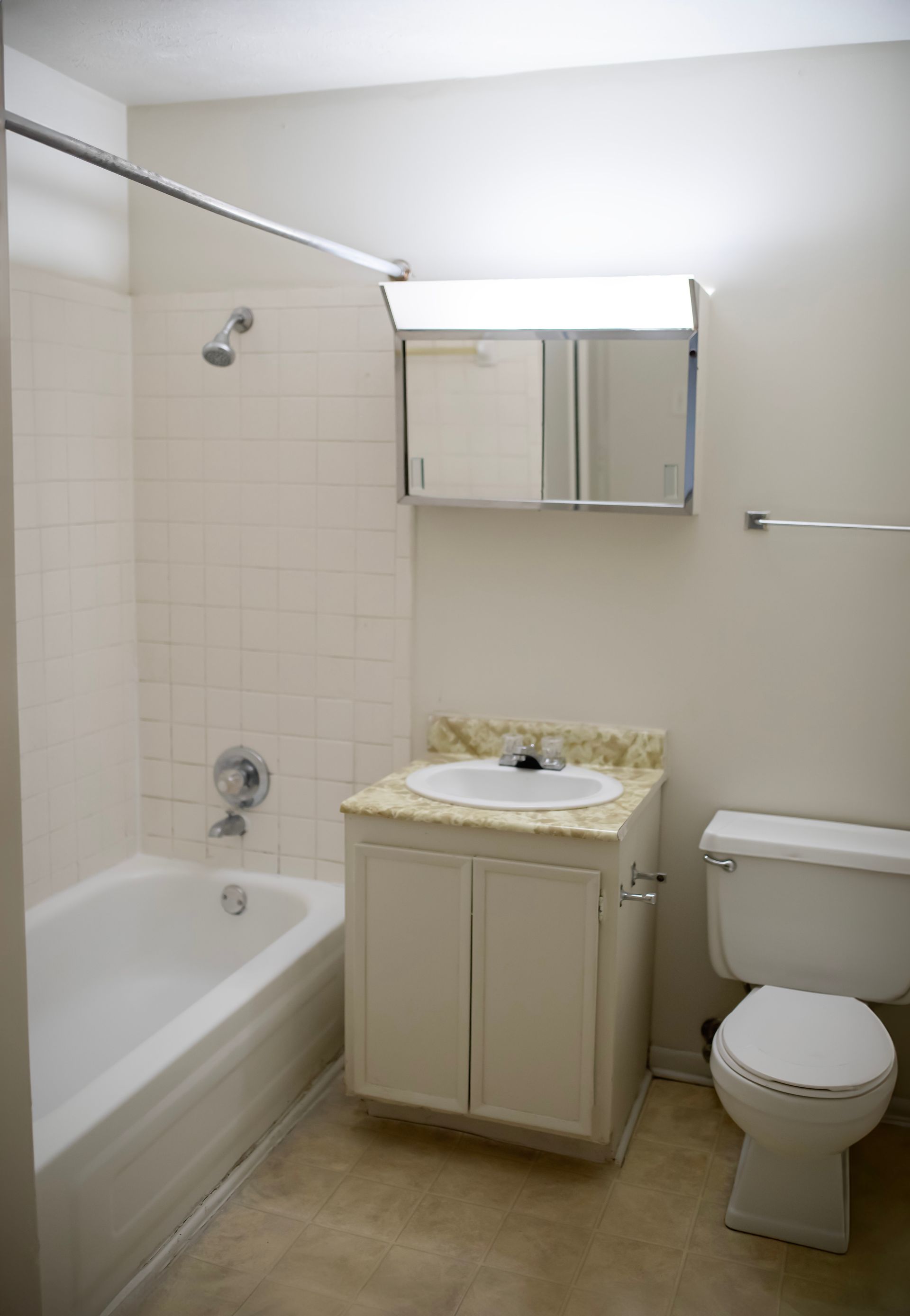 A bathroom with a sink toilet and bathtub