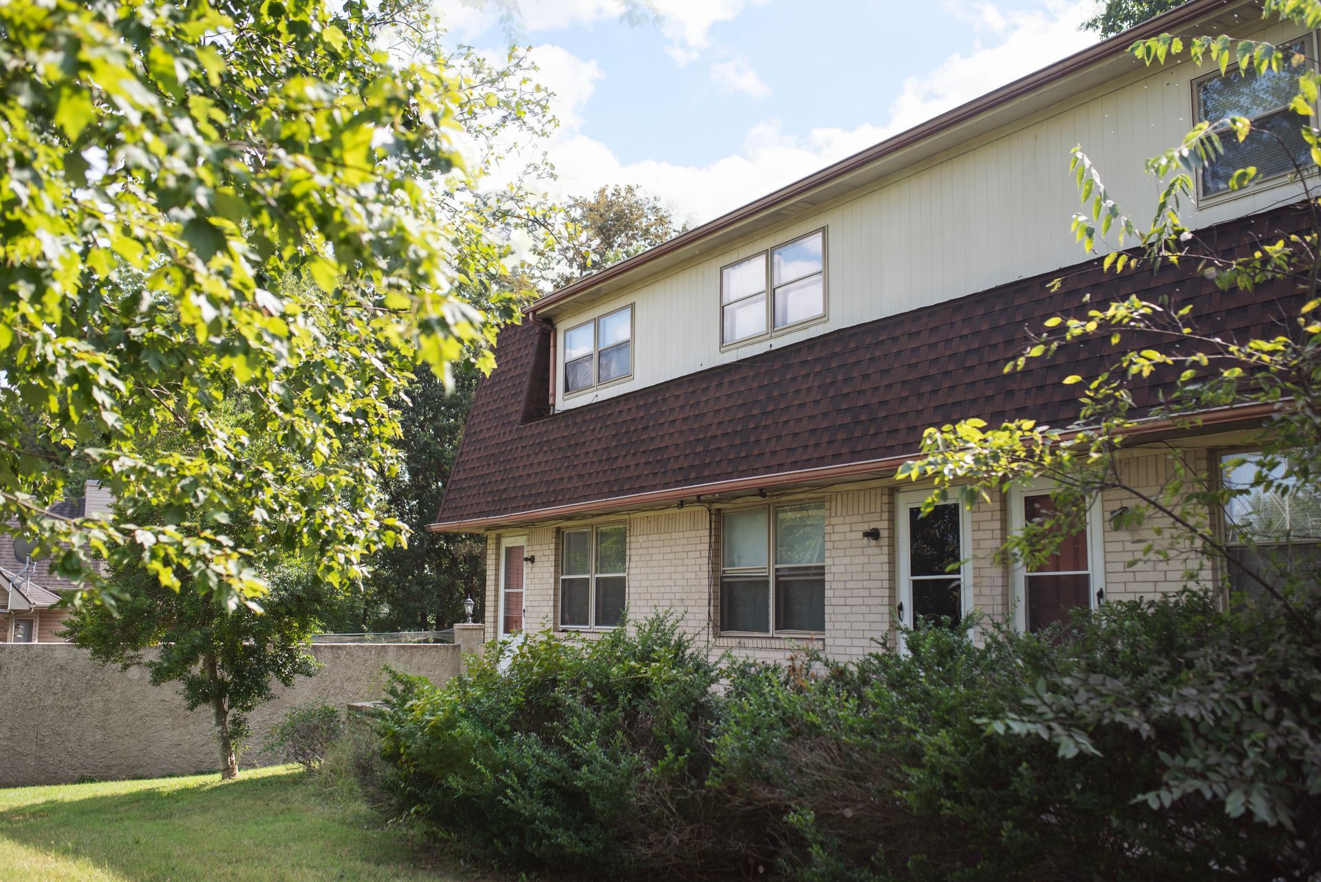 A house with a red roof and a lot of windows
