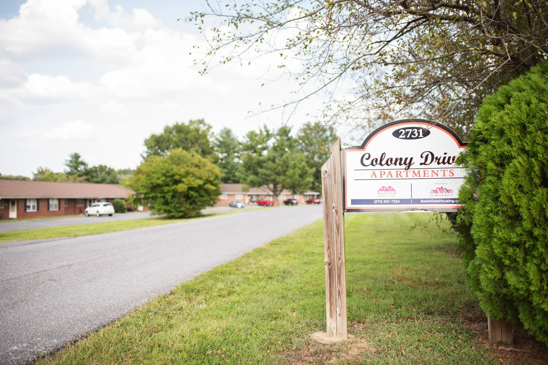 A sign for colony drive apartments is on the side of the road
