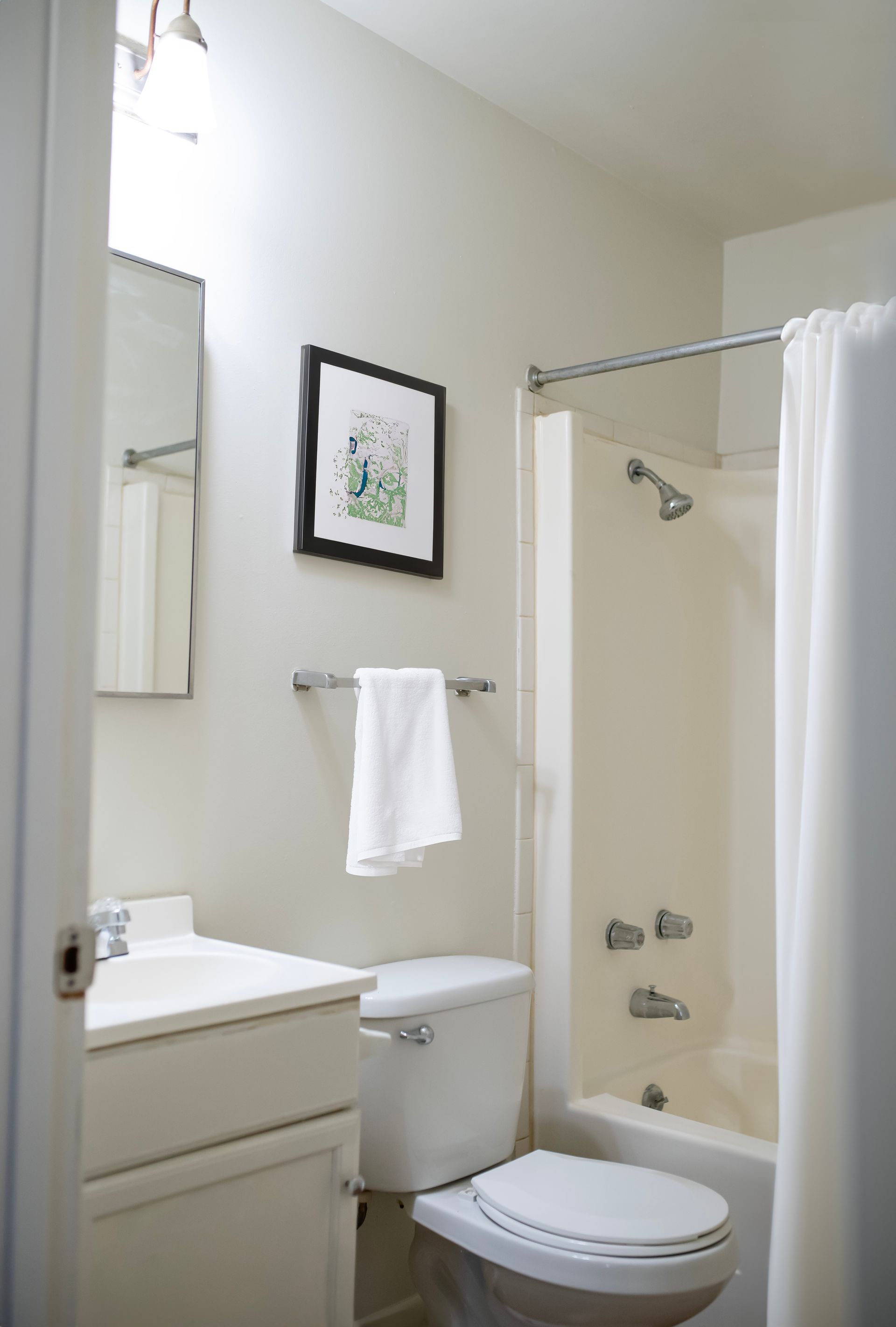 A bathroom with a toilet a sink and a bathtub
