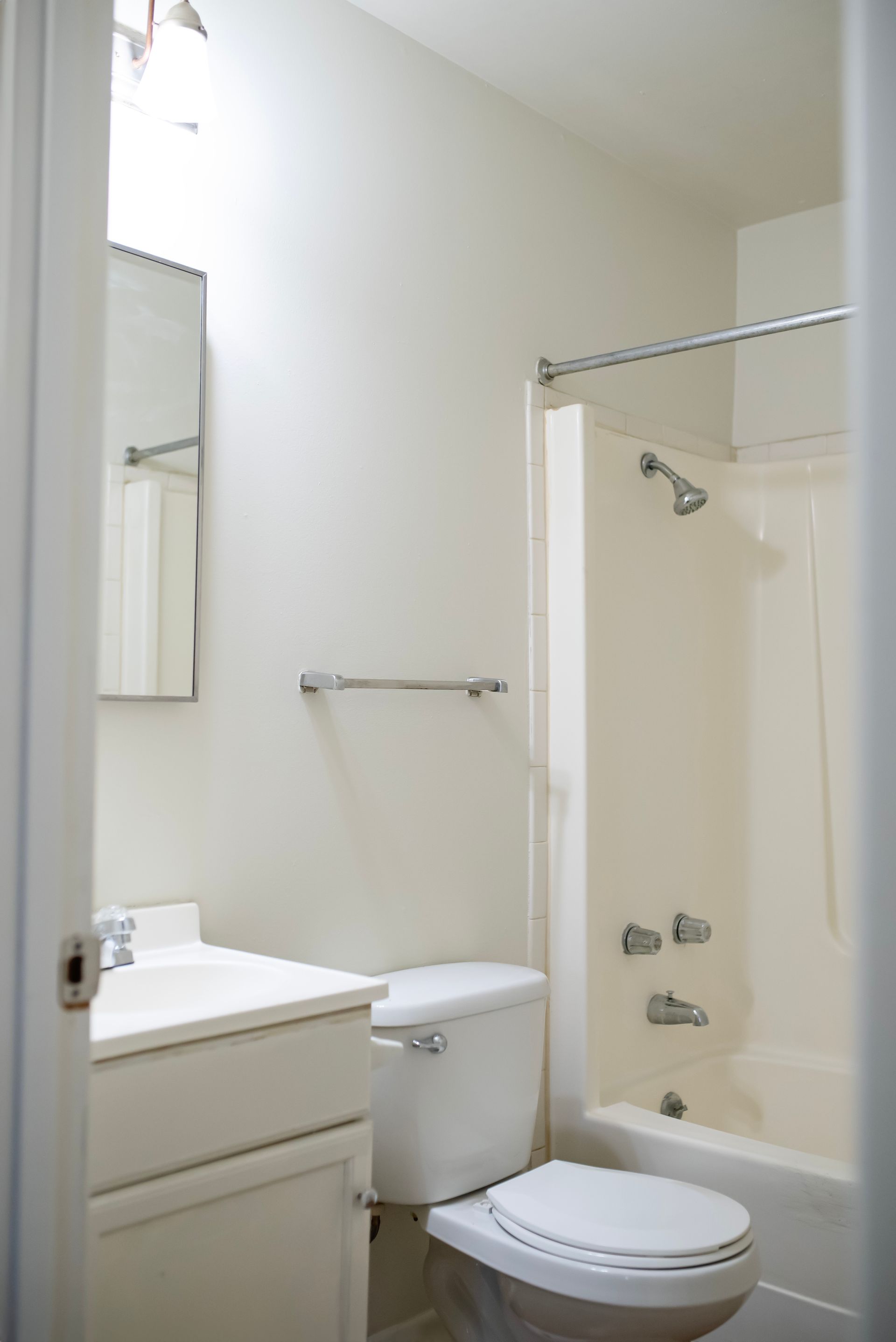 A bathroom with a toilet , sink and bathtub
