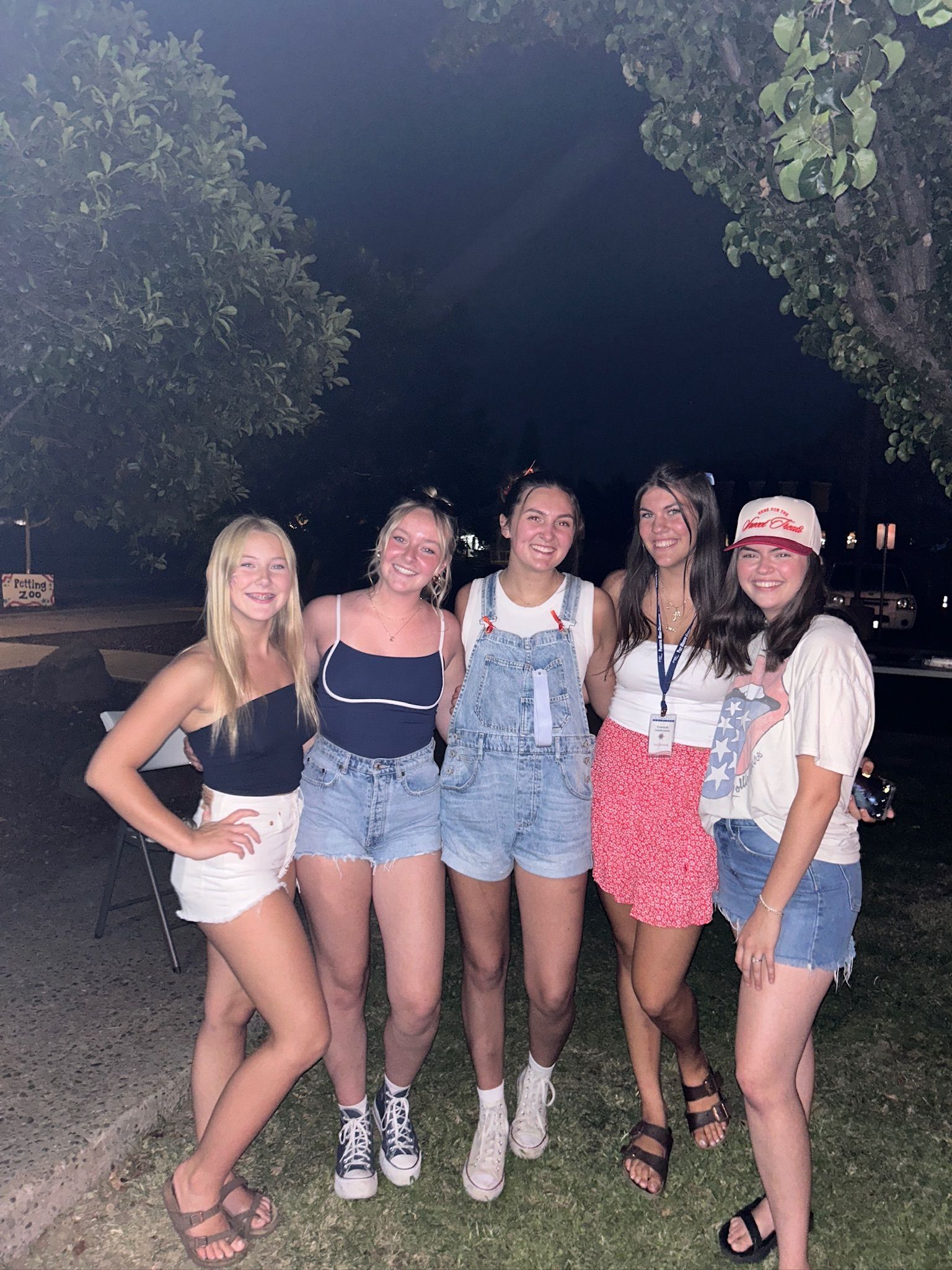 A group of young women are posing for a picture together.
