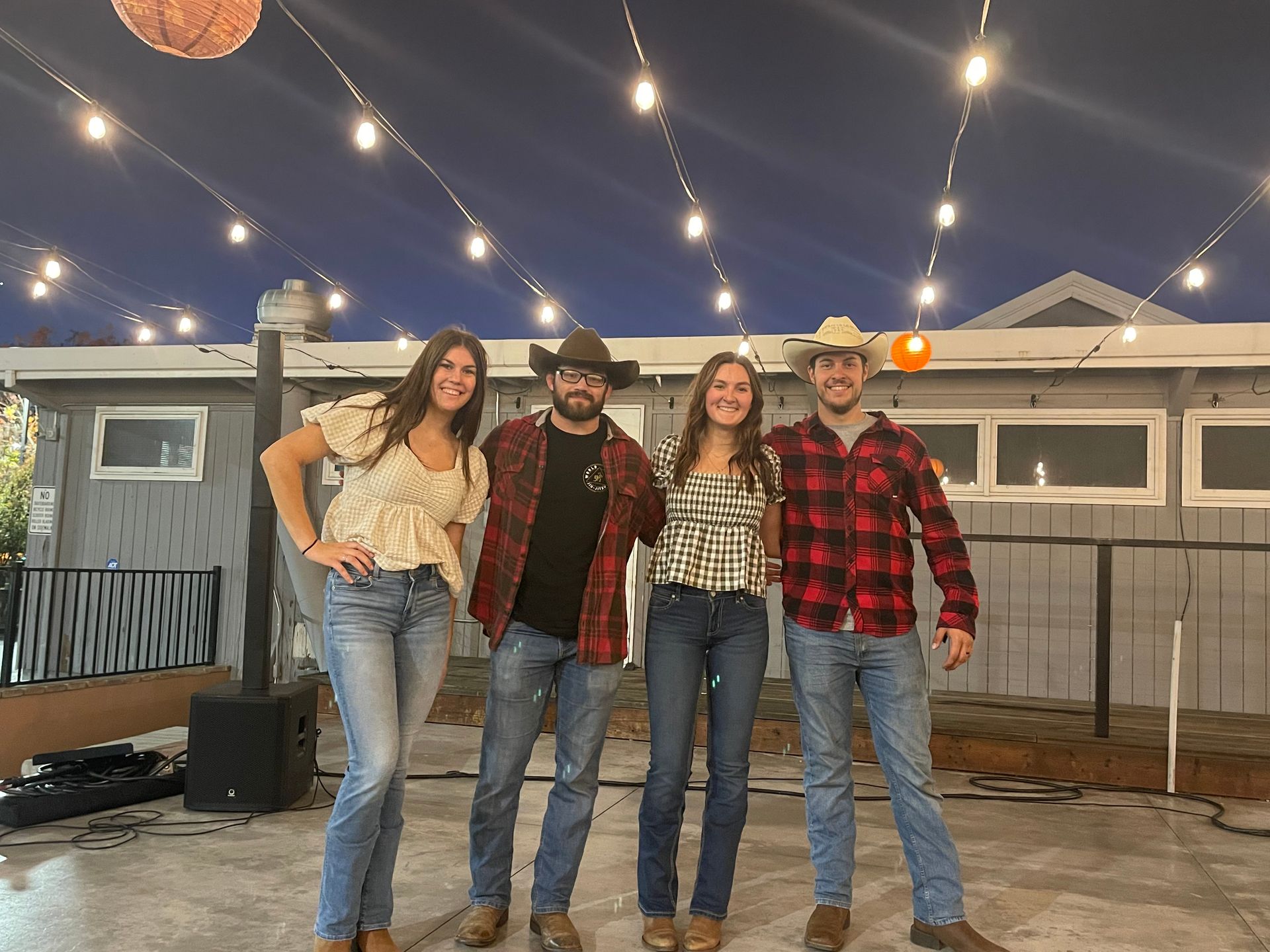 A group of people are posing for a picture in front of a house.